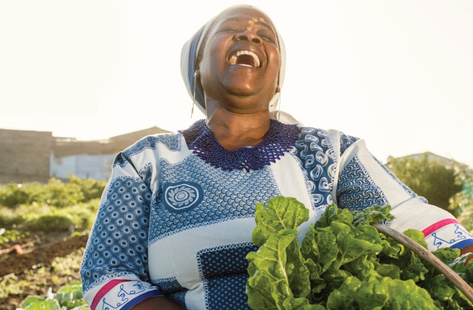 laughing veggie lady with a basket of spinach