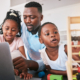 Black family, laptop and elearning, father and girl children, education and helping with math school work. Teaching, learning and support, black man with young female kids at home in online class.