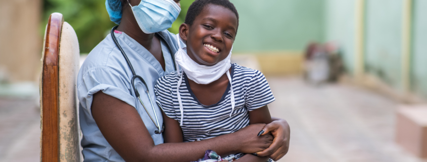 A closeup shot of a boy and a doctor wearing sanitary masks