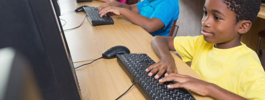 Cute pupils in computer class at the elementary school