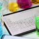 Digital tablet with periodic system of elements lying on table in laboratory closeup. Checking water quality concept