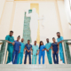 Group of african medical students in college standing on stairs.