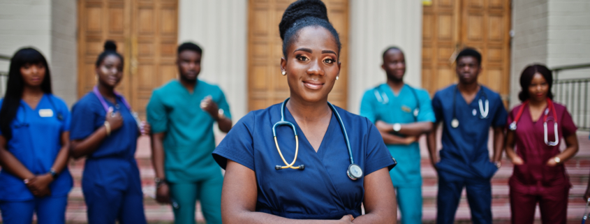Group of african medical students posed outdoor against university door.