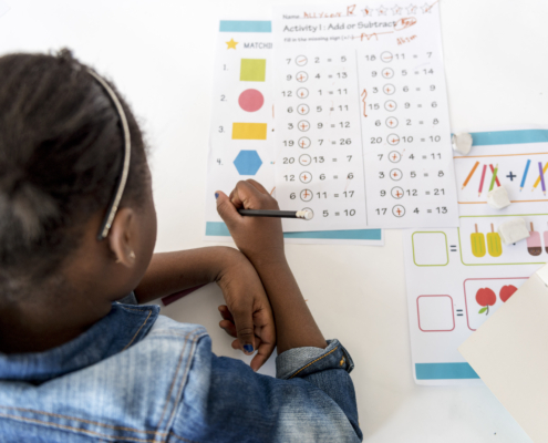 Kid Concentrating with Mathematics Homework Learning