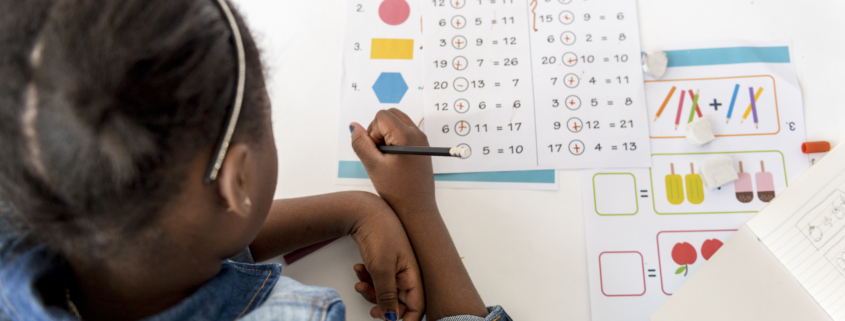 Kid Concentrating with Mathematics Homework Learning