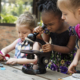Little Girls Using Microscope Learning Science Class