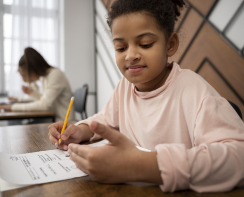 Child preparing for exams with sample test paper
