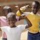 Excited African children with their hands up in the air