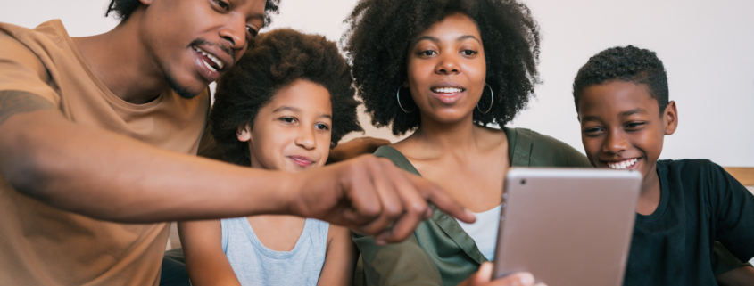 Portrait of african american family taking a selfie together with digital tablet at home. Family and lifestyle concept.