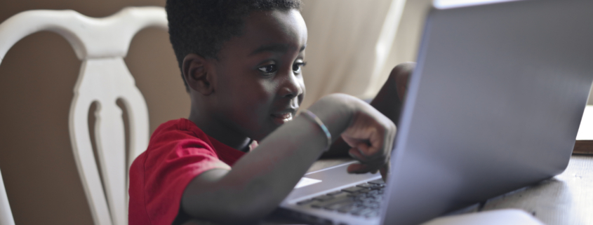 portrait of black child while doing homework