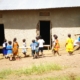 side-view-children-walking-against-house