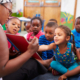 Teacher reading a book with a class of preschool children
