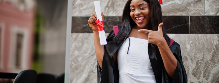 Young female african student with diploma poses outdoors. She got a bursary to attend university